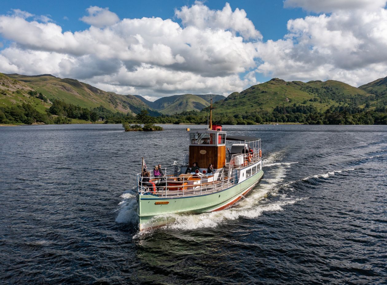 Heritage Vessel M.V. Western Belle sailing on Ullswater Lake on a sunny day.