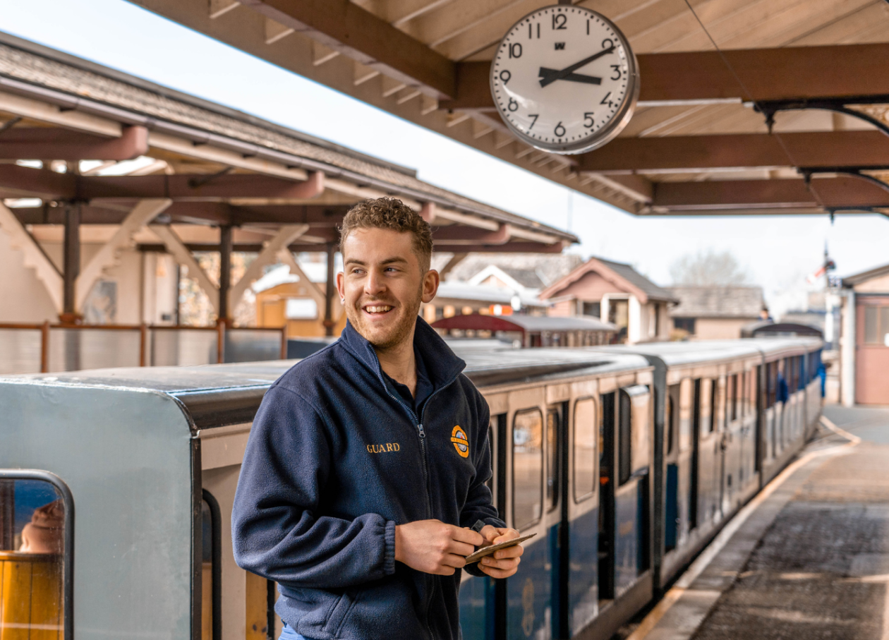A volunteer guard on the platform at Ravenglass station in the Western Lake District